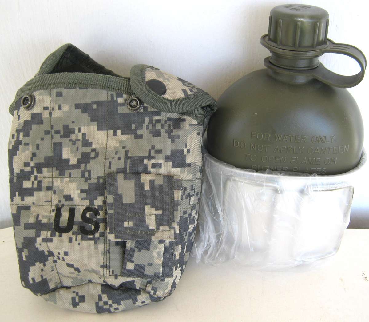 U.S.ARMY WATER BOTTLE WITH CAMO COVER AND FIRE BUCKET STILL IN IT'S WRAPPING SO UNUSED