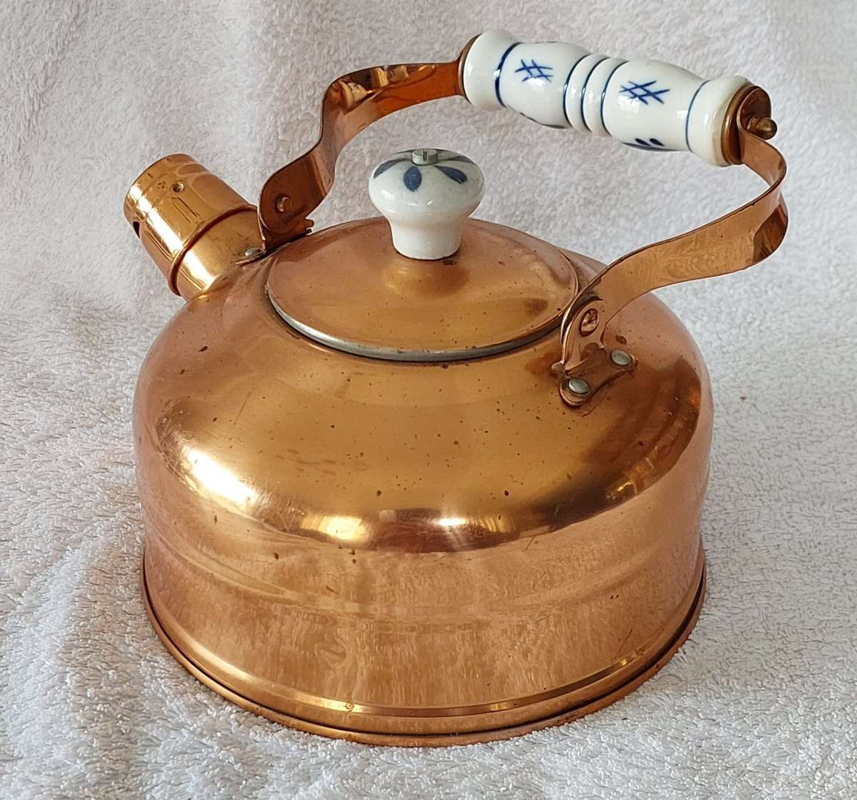 Copper kettle with nickel lining, whistle, porcelain handle and knob.