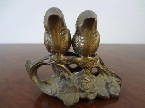 Pair of brass sparrows sitting very still as per photo