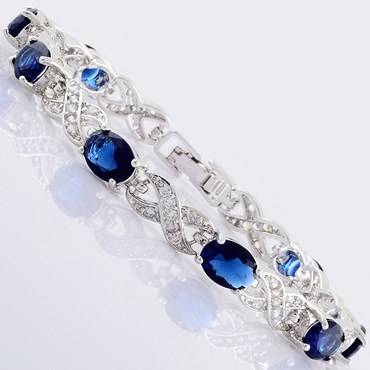**STUNNING WHITE GOLD OVAL CUT BLUE SAPPHIRE TENNIS BRACELET **