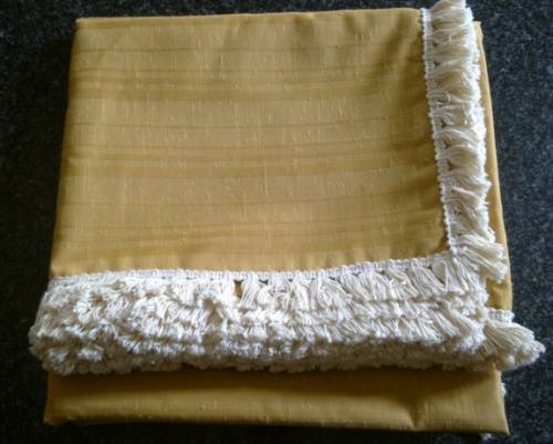 Large gold tablecloth with tassel trim