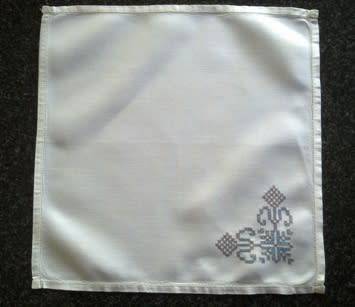 Ten hand embroidered white linen dinner serviettes