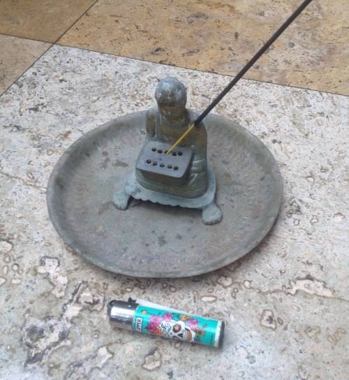 vintage brass buddha incense burner on brass plate