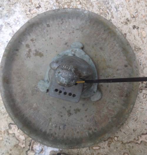 vintage brass buddha incense burner on brass plate