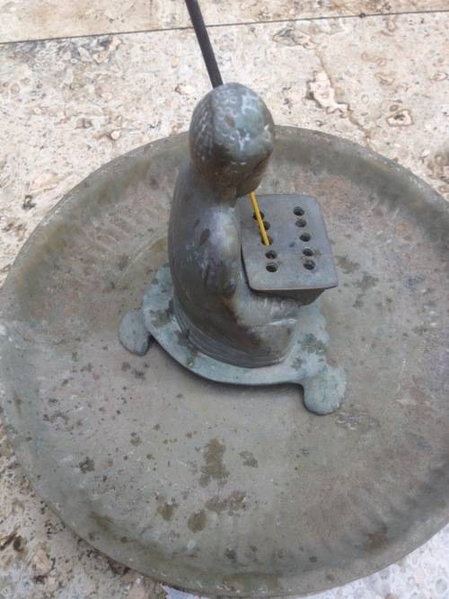 vintage brass buddha incense burner on brass plate