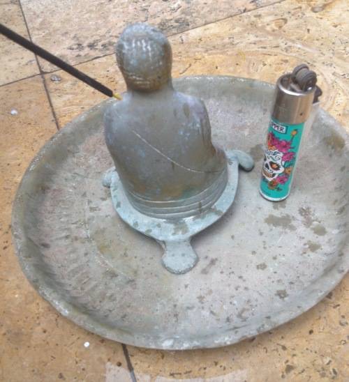 vintage brass buddha incense burner on brass plate