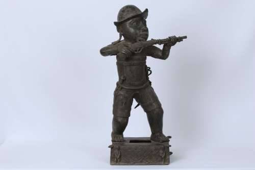 Brass figure of a Portuguese soldier holding a musket - Benin Nigeria