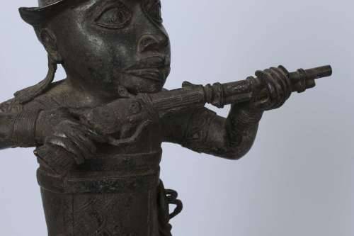 Brass figure of a Portuguese soldier holding a musket - Benin Nigeria