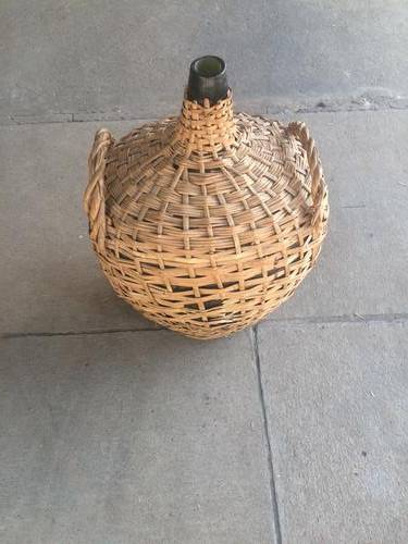 Huge Green Bottle with basket woven around it