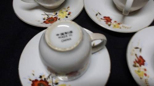 FIVE DEMITASSE CUPS AND SAUCERS