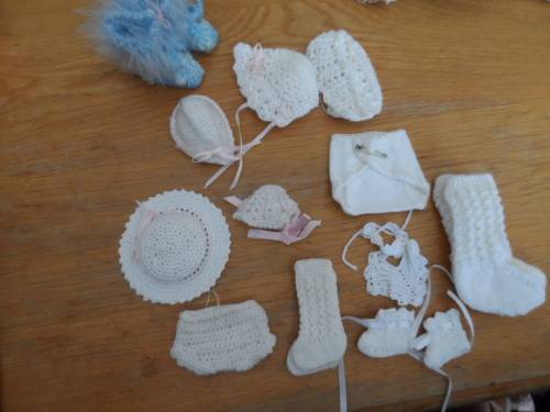 Beautiful handmade crocheted bibs and socks and hats for dolls.