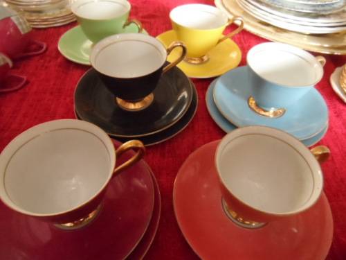 Unusual 6 cup and saucers three with matching sideplates.