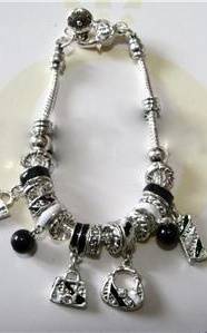 PRETTY PANDO BRACELET WITH BLACK & SILVER HANDBAG CHARMS.