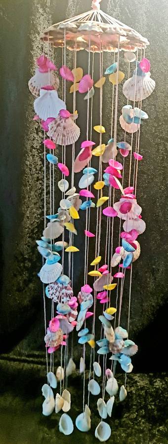 Fun and flirty. Pink, blue and yellow shell windchime
