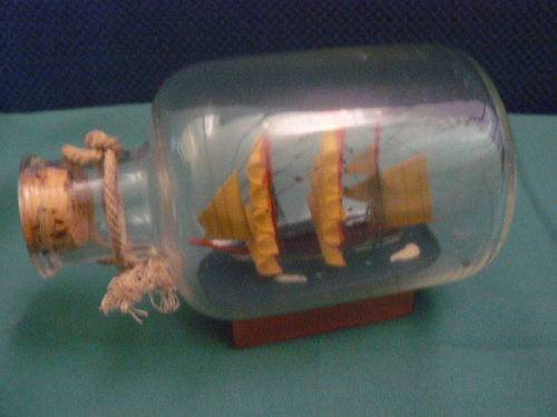 SHIP IN GLASS BOTTLE CORKED AND WOODEN STAND