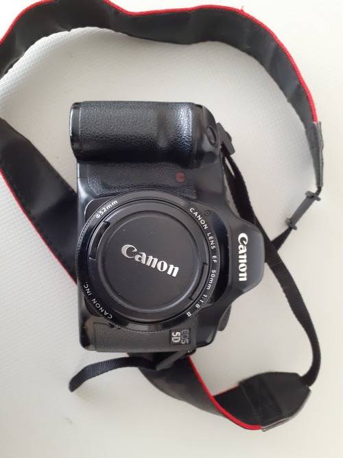 Used Canon 5D camera with Canon 50 mm f1.8 lens plus battery , charger and  plus Yongnuo speedlite a