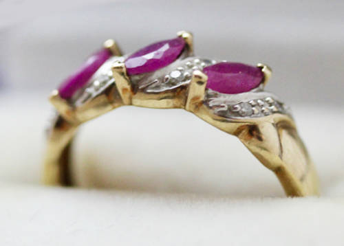 VINTAGE 9CT HALF ETERNITY YELLOW AND WHITE GOLD RUBY AND DIAMOND RING. 375