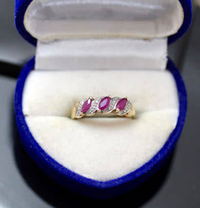 VINTAGE 9CT HALF ETERNITY YELLOW AND WHITE GOLD RUBY AND DIAMOND RING. 375