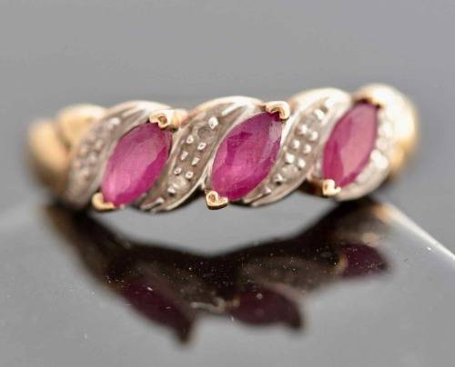 VINTAGE 9CT HALF ETERNITY YELLOW AND WHITE GOLD RUBY AND DIAMOND RING. 375