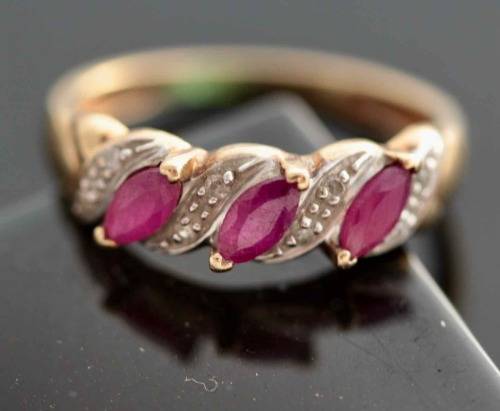 VINTAGE 9CT HALF ETERNITY YELLOW AND WHITE GOLD RUBY AND DIAMOND RING. 375