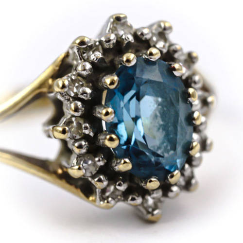 CLASSIC DESIGN  LONDON BLUE TOPAZ SOLITAIRE AND REAL DIAMOND FRAME 9CT YELLOW GOLD RING. 375.