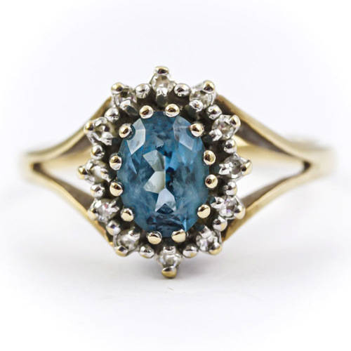 CLASSIC DESIGN  LONDON BLUE TOPAZ SOLITAIRE AND REAL DIAMOND FRAME 9CT YELLOW GOLD RING. 375.