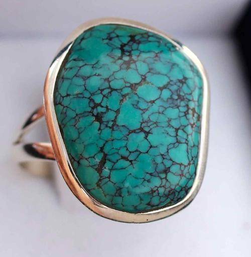 NATURAL TURQUOISE GEMSTONE WITH INTERESTING DARK INCLUSIONS. LARGE RING SET IN STERLING SILVER!