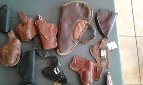 COLLECTION OF 28 PISTOL/ REVOLVER HOLSTERS. WIDE ASSORTMENT. ONE BID..