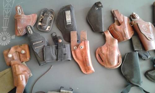 COLLECTION OF 28 PISTOL/ REVOLVER HOLSTERS. WIDE ASSORTMENT. ONE BID..