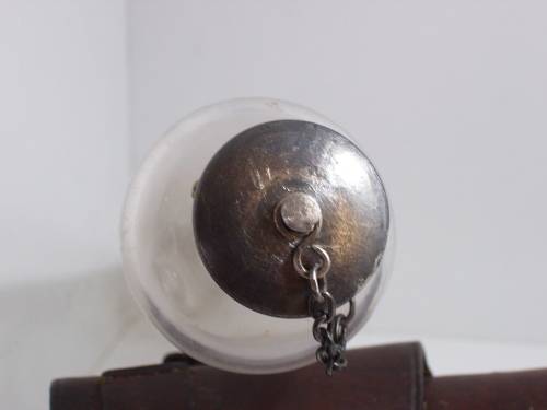 Antique saddle flask glass with leather holder.
