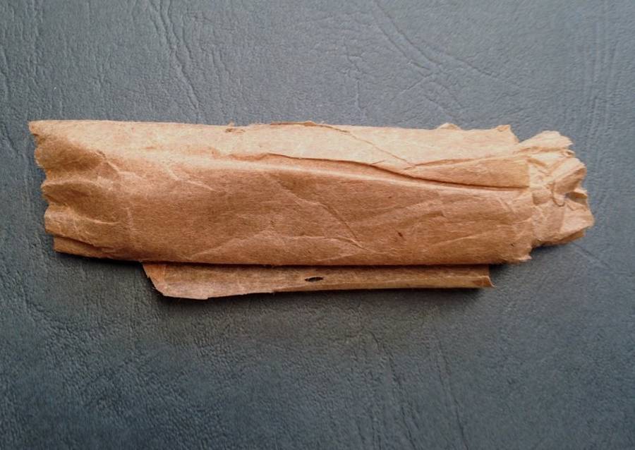 Vintage carbon steel pocket knife, unused in original brown paper wrapping.