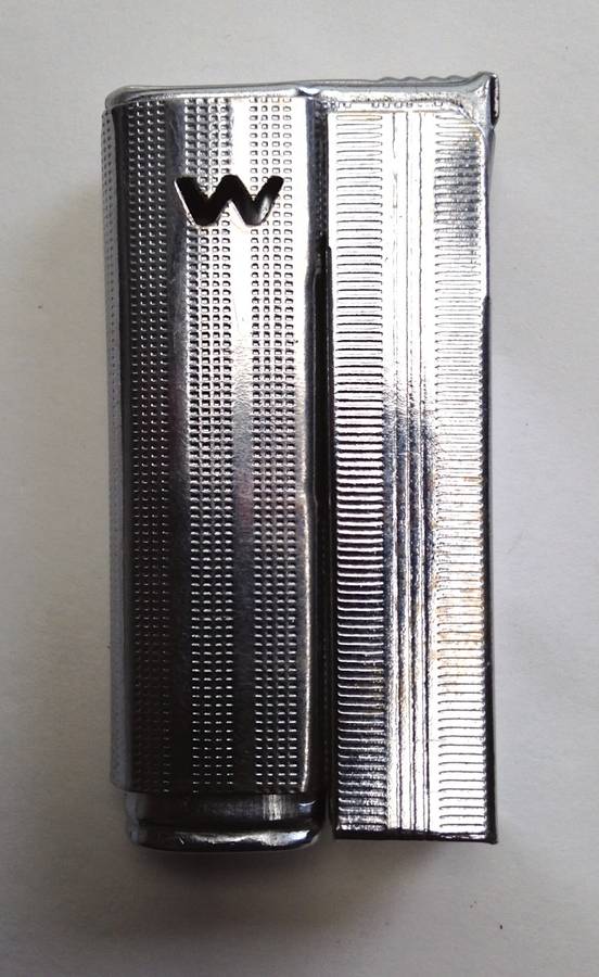 Vintage fluid and flint lighter "W" with removable fuel tank.