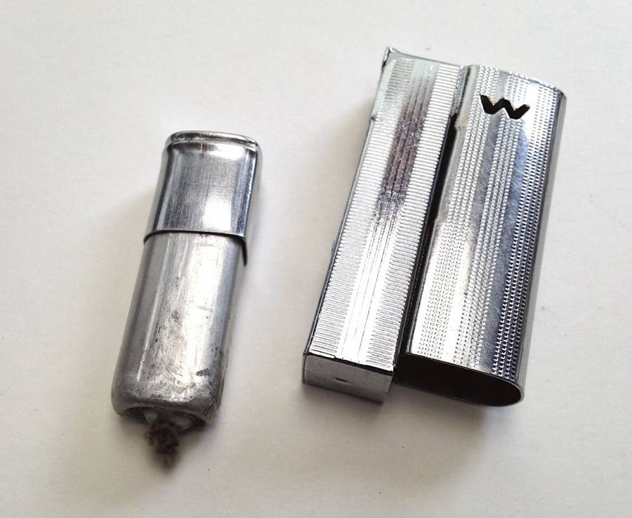 Vintage fluid and flint lighter "W" with removable fuel tank.