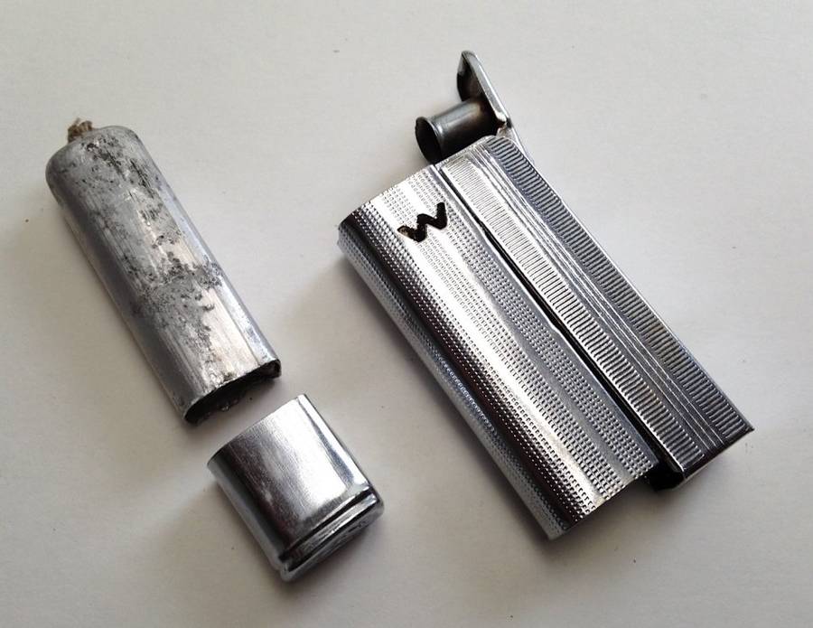 Vintage fluid and flint lighter "W" with removable fuel tank.