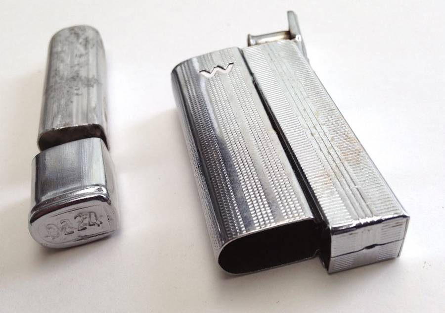Vintage fluid and flint lighter "W" with removable fuel tank.
