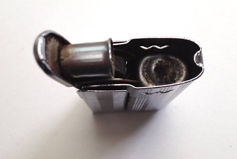 Vintage fluid and flint lighter "W" with removable fuel tank.