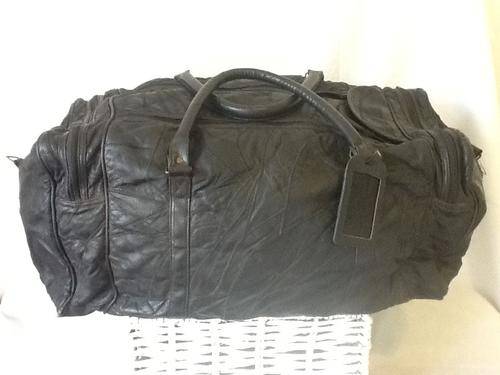 A Large Black Leather Carry Bag.