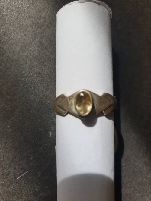 A siver ring with yellow stones cushion cut stone