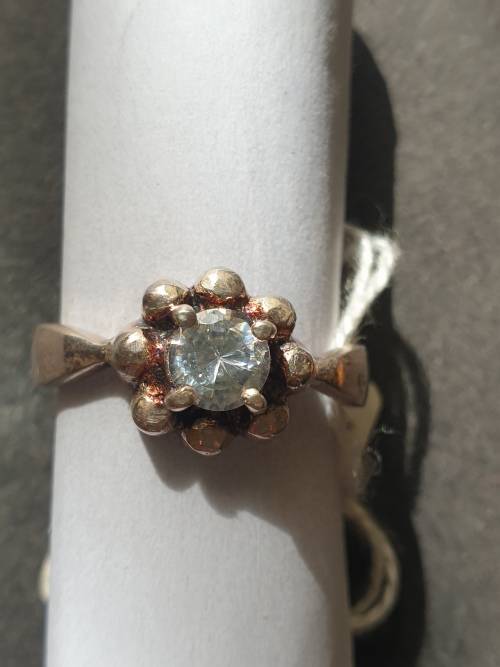 A siver ring with white stones round cut stone