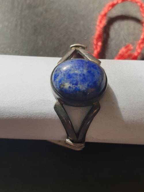 A siver ring with blue stones ovel cut stone