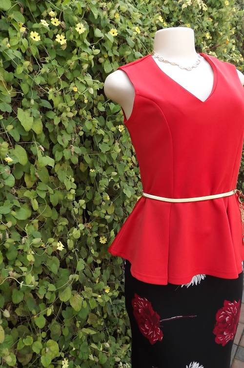 Chic bright peplum top with v neck in heavy polyester wash + wear fabric.Size 36/12.Beautiful fit
