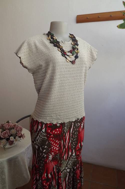 Beige stretch bubble top pull over in box style.Size 36/12.Comfortable and easy wear top.