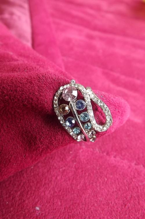 Dainty silver toned ring with lots of colourful stones.Pretty design.Rhodium plated .Size 7. New