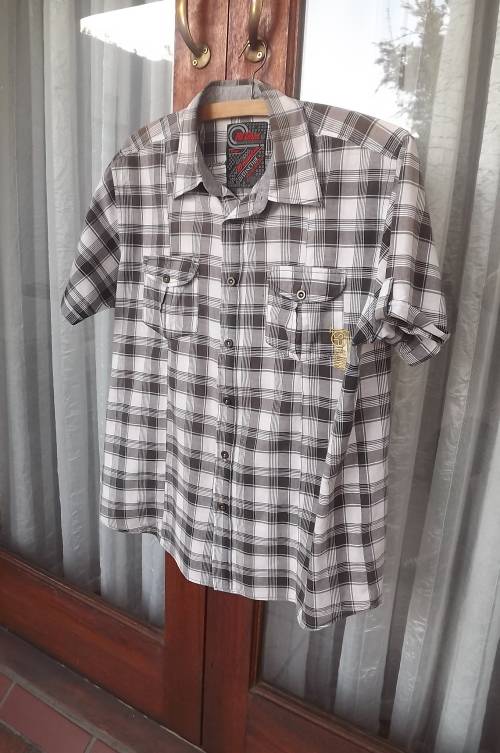 Stylish casual brown check polycotton shirt.Size Large.Chest 108cm.Fold over short sleeves.