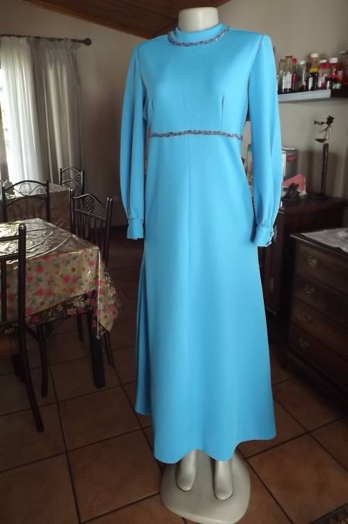 Sky blue vintage long crimplene dress with high neckline.Size 36/12.Long cuffed sleeves.