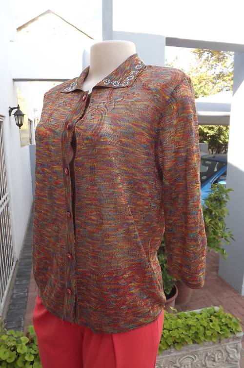 Soft acrylic knit top/cardigan.In rainbow colours. Patterned .Partly see-through.Size 38/14