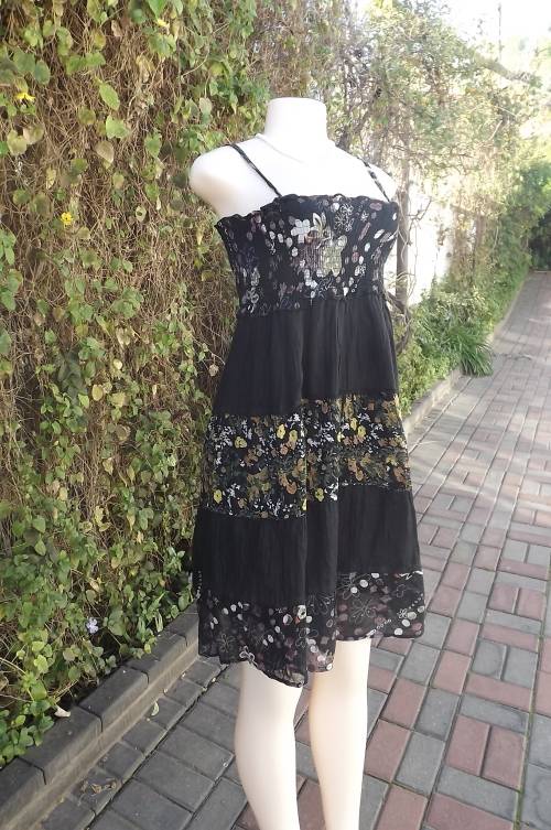 Cool black cotton tiered dress with black floral inlays.By CAHIER SAUVAGE.Size 32/8