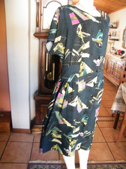 Black FASHIONETTE dress with geometric pink/green designs.Size 42/18.Button down front