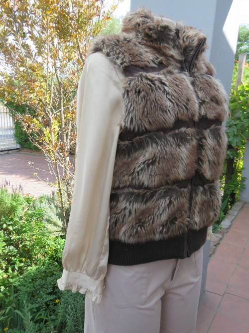 Warm and cosy zip-up brown faux fur waist coat with knitted waistband.Size 38/14.New condition
