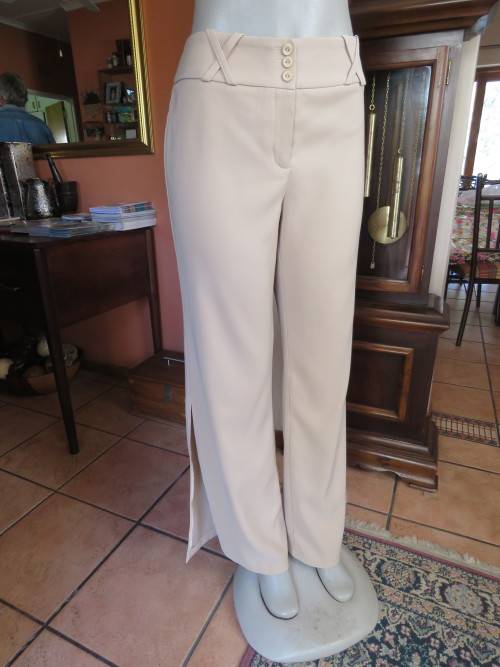 Smart cream colour pants by 'OASIS'.Size 36/12.Bootlegged with long slitted sides.New condition.